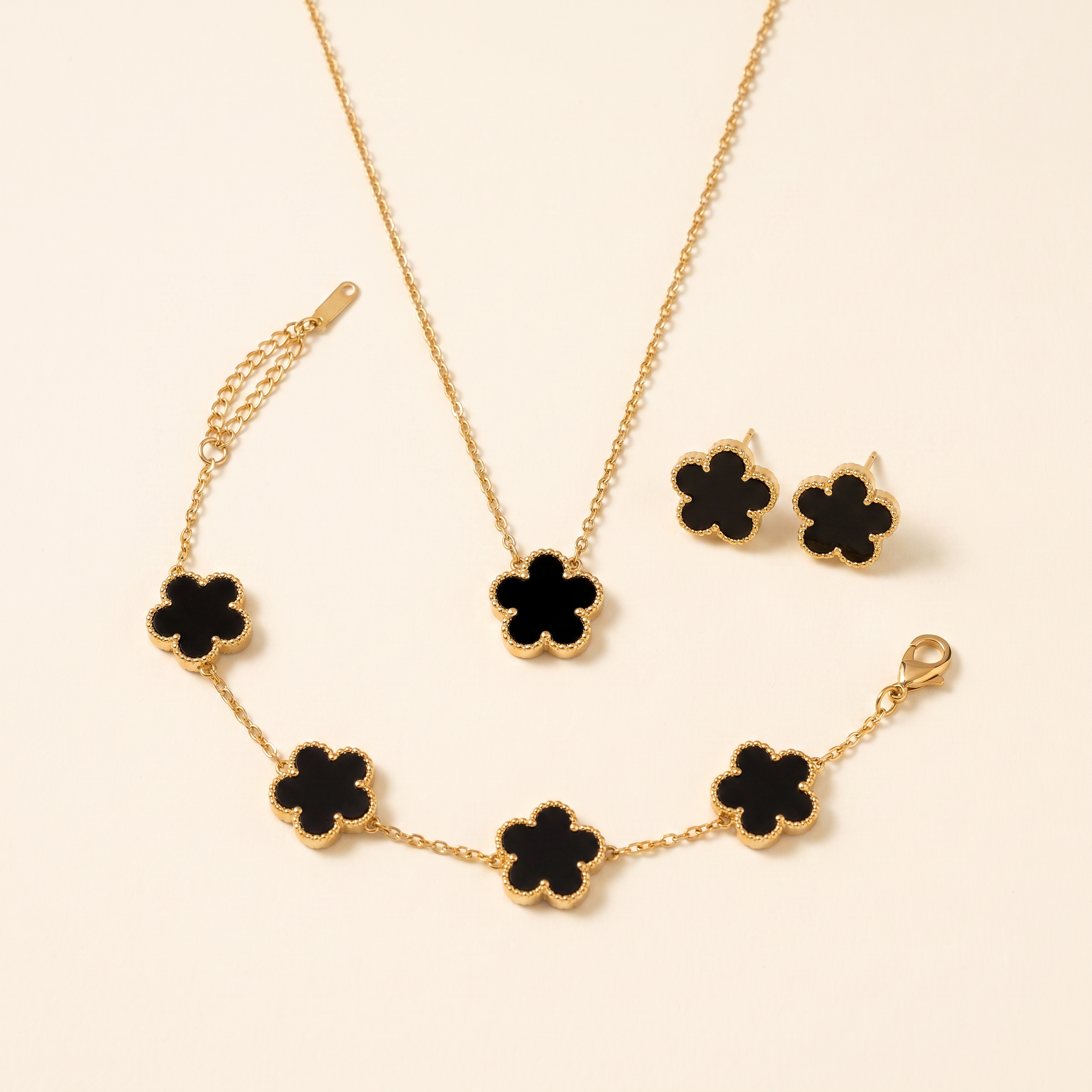 Set Bloom Negro con collar, pulsera y pendientes de flores negras y borde dorado